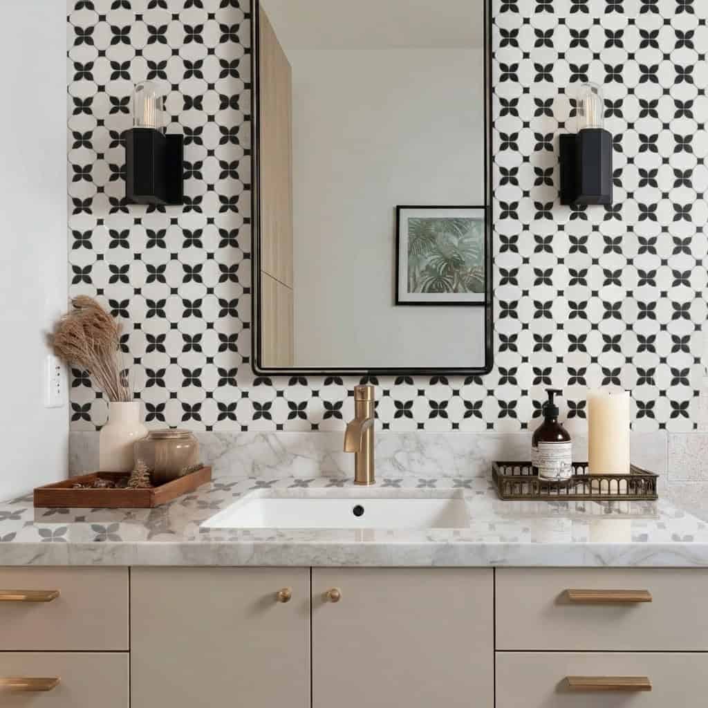 Black and white geometric patterned tiles with matte finish, used as a decorative wall feature behind the mirror.