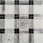 White marble tiles with gray veining and black accent tiles.