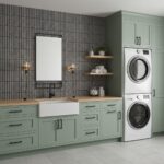 Dark gray textured tile backsplash, mint green cabinets, and white washer and dryer.