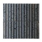 Grey concrete tile with black and rust-colored speckles, textured surface, and cylindrical shape.