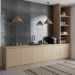 Gray ceramic wall tiles with a matte finish, textured surface, and subtle variation in shades complement the light wood cabin.