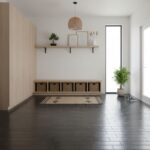 Entryway with beige wood paneling, black tiled floor, and minimalist decor.