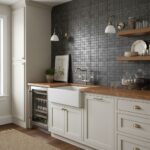 Dark gray textured ceramic tiles create a modern, sophisticated backsplash in this kitchen.