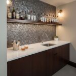 Image of a modern kitchen backsplash with peel and stick tiles above a white countertop.