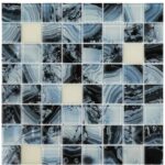 Up of a glass tile mosaic featuring shades of blue, black, and white with intricate veining and glossy finish.
