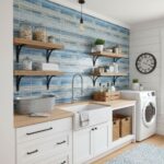 Blue glass tile backsplash in laundry room with open shelves and washer.
