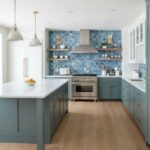 Glass tile backsplash in a contemporary kitchen with blue mosaic tiles and sleek cabinetry.