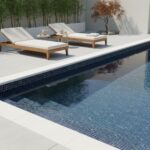 Poolside glass mosaic tile enhances outdoor pools with a sleek, reflective surface.