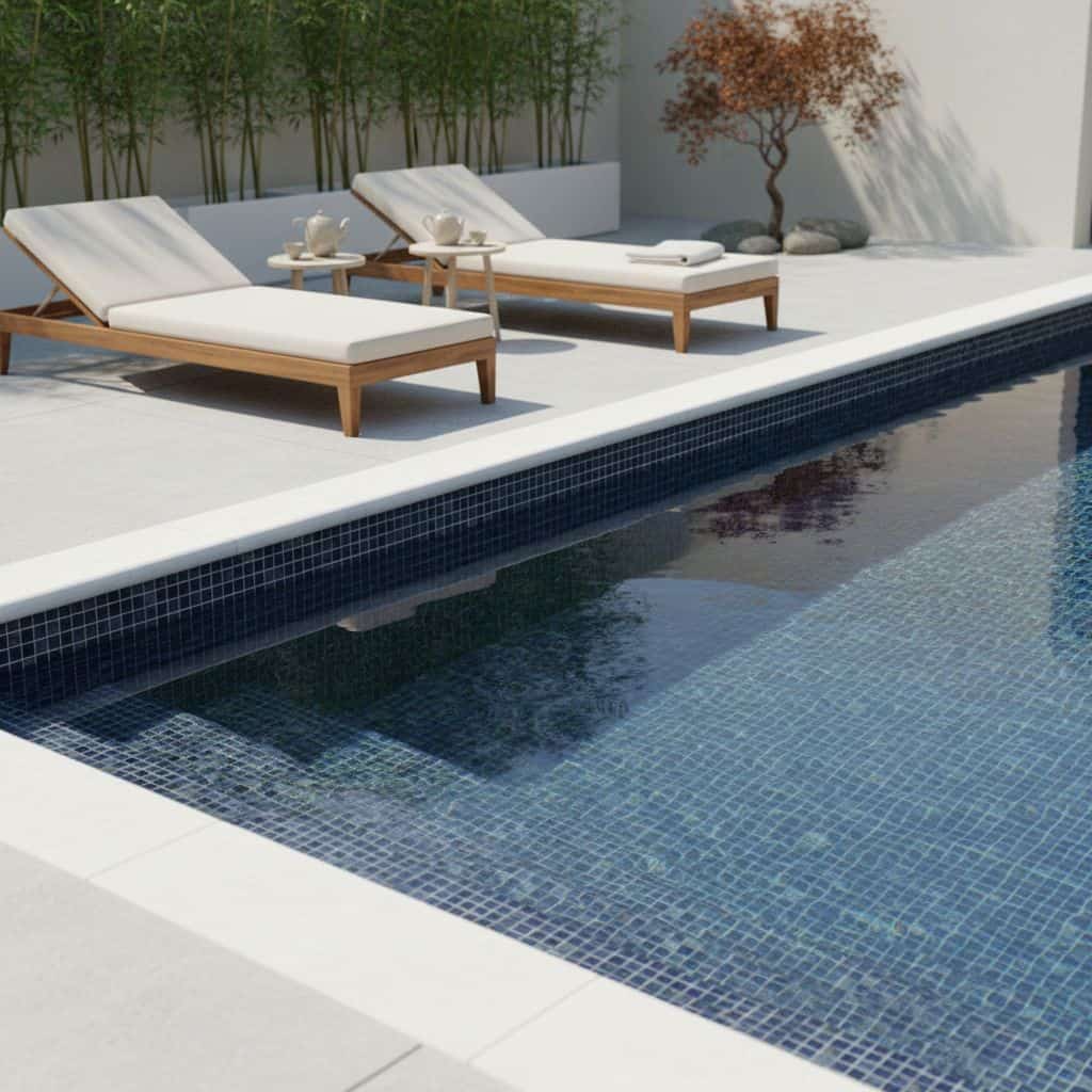 Poolside glass mosaic tile enhances outdoor pools with a sleek, reflective surface.