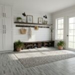 Bright white mudroom with wooden shelves, black wall sconces, and potted greenery. Features a textured rug, coat rack, and na.