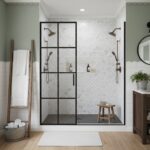 Bright white subway tiles with a glossy finish and a black metal-framed glass shower door.