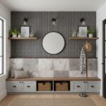 Gray textured tile wall with wooden shelves, round mirror, and decorative plants.
