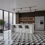 Black and white geometric patterned tiles, sleek stainless steel refrigerator, and contemporary bar stools.