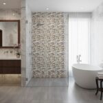 Elegant bathroom with a shell tile accent wall and a modern freestanding bathtub. Bright, airy space featuring luxurious pear.