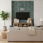 Modern living room with peel and stick wall tile behind TV, featuring a cozy sofa, plants, and decorative frames.