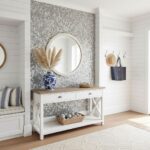 A stylish entryway with peel and stick wall tiles, a mirror, and decorative accents creating a welcoming space.
