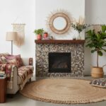 Fireplace with pebble tile in natural earthy tones, textured surface, and boho decor accents.