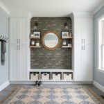Peel and stick wall tile accent in a modern, light-filled entryway with built-in storage and decorative shelves.