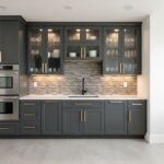 Modern kitchen with peel and stick tile backsplash, dark cabinetry, and under-cabinet lighting.