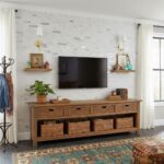 Modern living room featuring peel and stick wall tile behind a flat-screen TV, with decorative shelves and a wooden console.