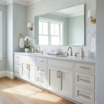 A bathroom vanity with a large mirror, featuring a shell tile backsplash made of mother of pearl, creating a luxurious and el.
