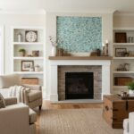 Mother of pearl shell tile above fireplace with seashell accents and books, creating a coastal-inspired living room focal poi.
