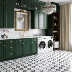 Green cabinets with gold handles, white countertop, and black-and-white patterned tile floor.