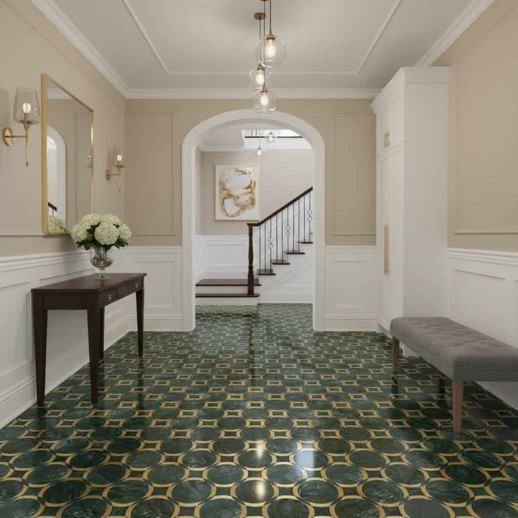 Bright entry hall featuring a green and gold patterned tile floor, white walls, and classic decor accents.