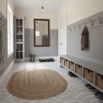 Neutral-colored rug and wall hooks in a cozy entryway.