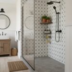 Geometric patterned white and black tiles in a contemporary bathroom shower.
