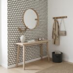 Geometric patterned tile wall in black and white, with a smooth matte finish, used as an accent behind a wooden console table.