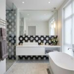 Elegant black and white floral patterned tiles in the bathroom.