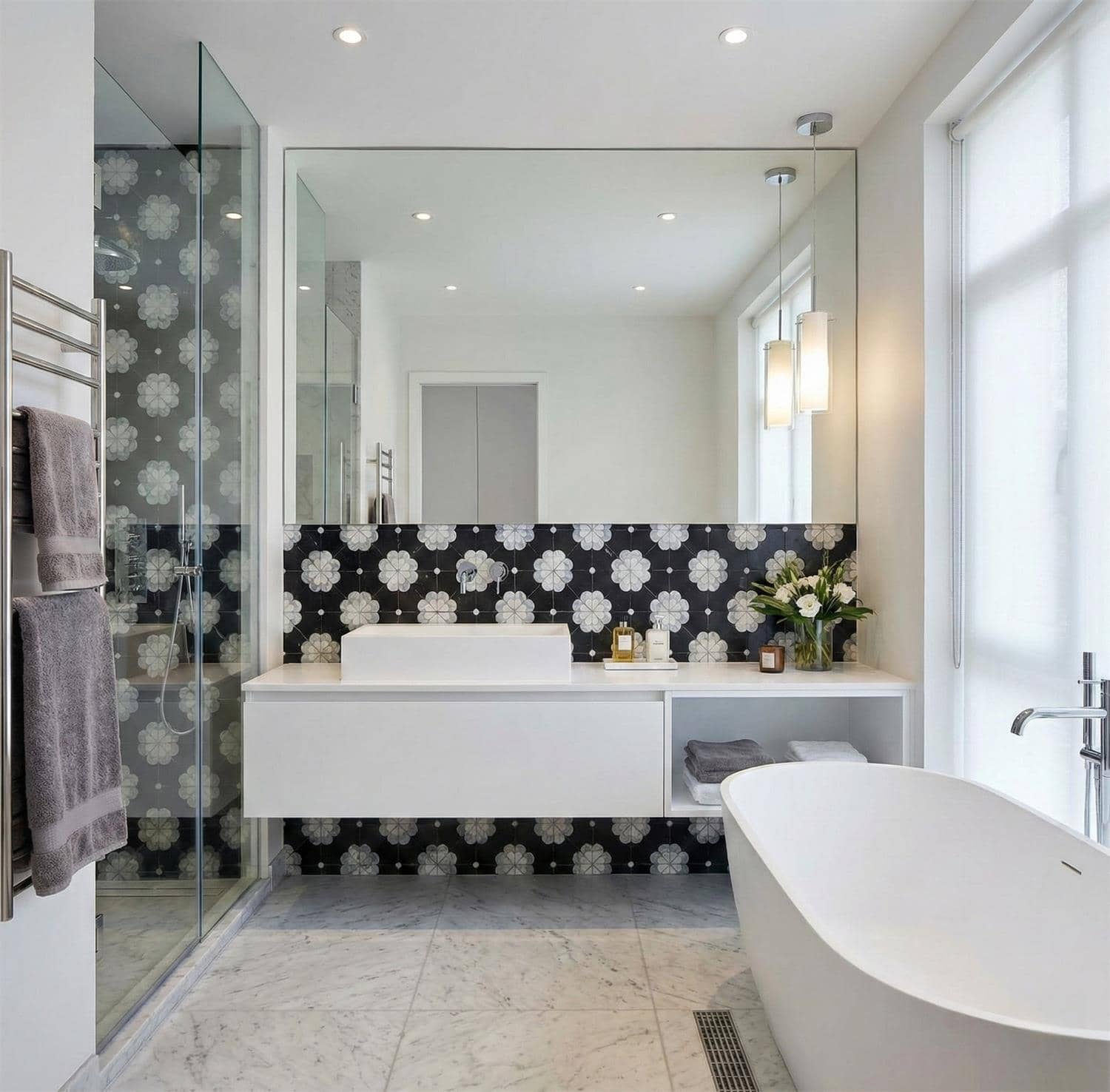 Elegant black and white floral patterned tiles in the bathroom.