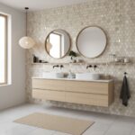 Two round mirrors above a modern double sink vanity with peel and stick wall tiles. Minimalist bathroom design with natural l.