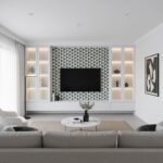 Bright living room featuring geometric patterned wall tiles in shades of gray and white, with sleek white shelving and contem.