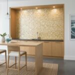 Mother of pearl shell tile used as a decorative kitchen backsplash, featuring iridescent pearl and seashell textures.