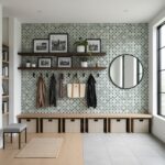 Decorative wall tiles with geometric pattern, wooden shelves, and round mirror in modern entryway.