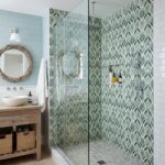 Green and white leaf-patterned ceramic tile in shower.