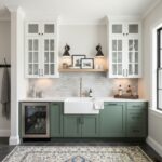 Bright kitchen featuring peel and stick wall tile and stylish green lower cabinets.