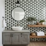Gray and white geometric tile wall with wooden shelves and modern bathroom fixtures.
