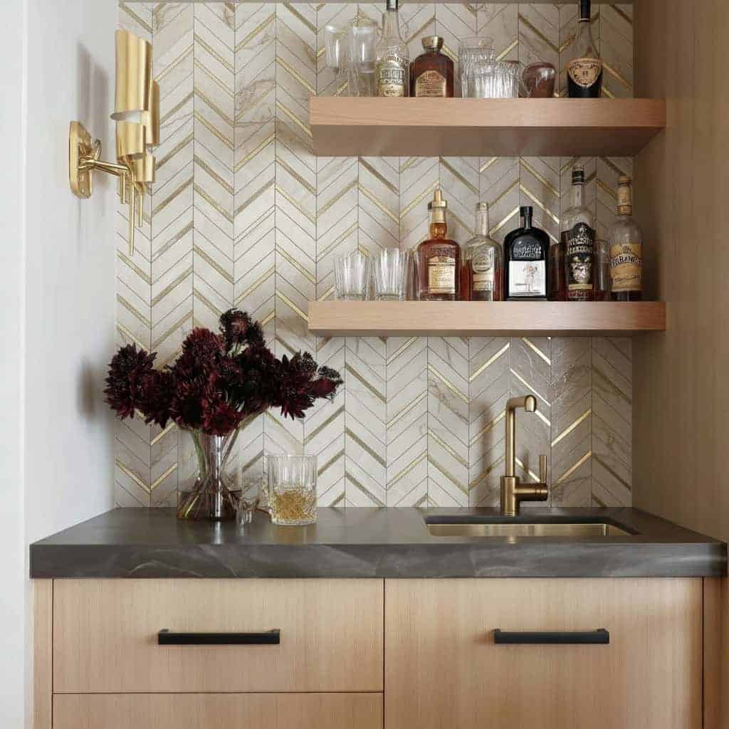 Modern kitchen with peel and stick tile backsplash, wooden shelves, and gold fixtures.
