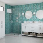 Glass tile backsplash in bathroom with double vanity and mirrors.