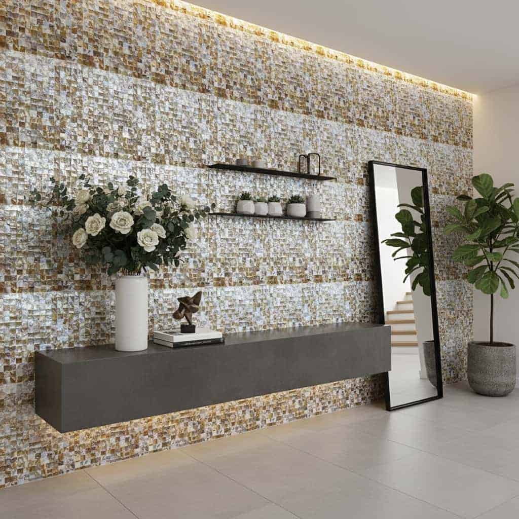 A stylish interior featuring a wall decorated with mother of pearl shell tiles, complemented by a large mirror, potted plants.