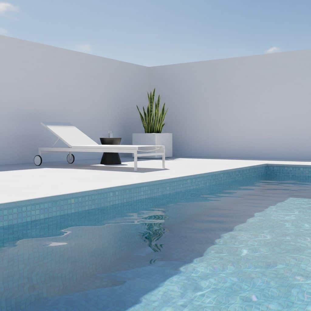 Poolside scene featuring a glass mosaic tile pool and a sleek lounge chair with a potted plant in the background.