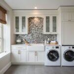 Elegant laundry room featuring a beautiful mother of pearl shell tile backsplash behind the sink.