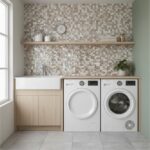 Modern laundry room featuring a stylish seashell tile backsplash, washer, dryer, and a wooden shelf with decorative items.
