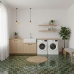 Bright laundry room with green and beige patterned tiles, white walls, wooden accents, and minimal decor for a clean, modern.