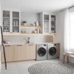 Modern laundry room with peel and stick wall tiles, washer, dryer, and minimalist decor.
