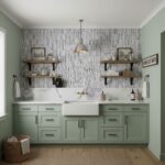 A bathroom with a textured gray tile wall, light green cabinetry, and open wooden shelves holding decor and toiletries.