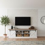 A modern living room featuring a wall decorated with elegant mother of pearl shell tiles behind a flat-screen TV.